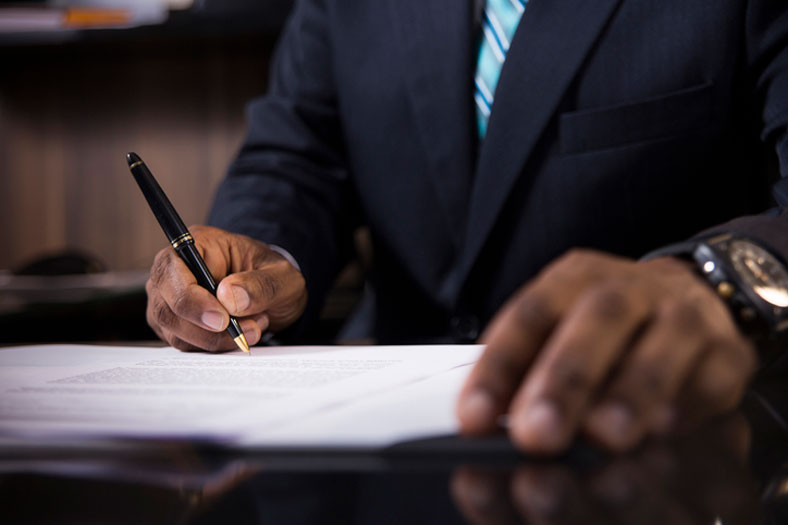 lawyer signing papers